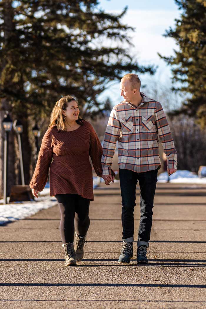 Couple walking down a road, holding hands